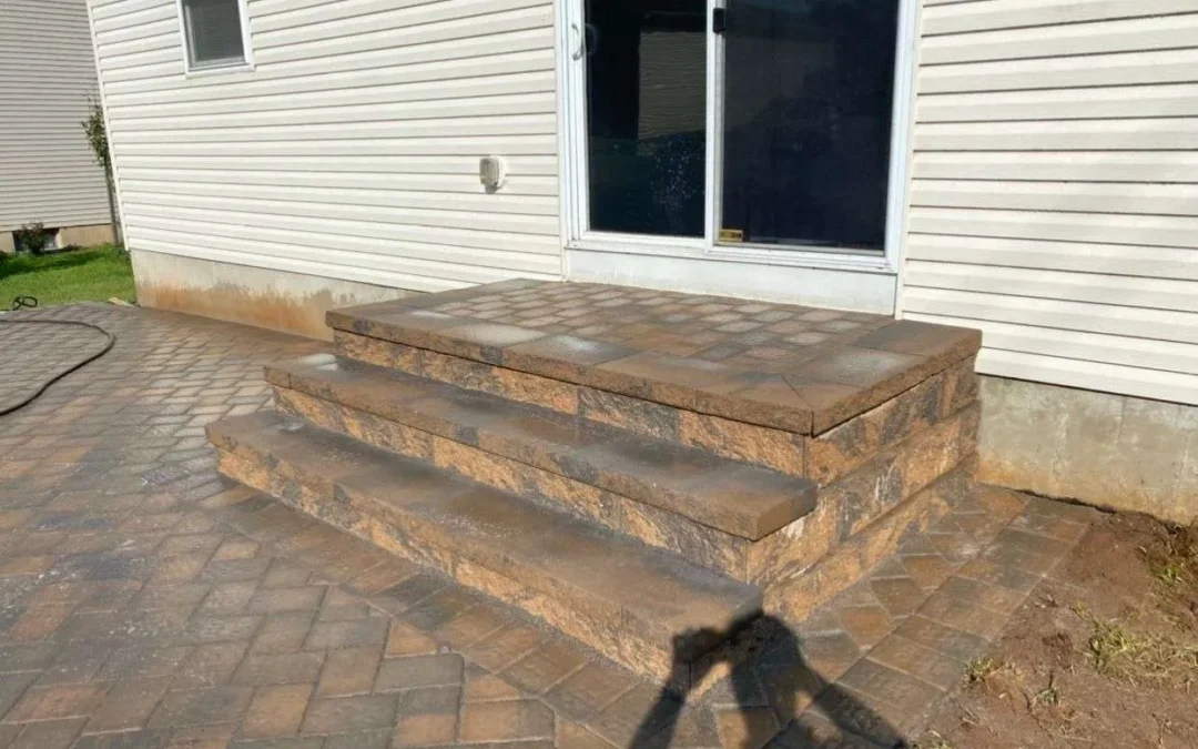 Masonry contractors in Montville NJ installing a paver patio and stone retaining wall